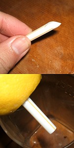 A small amount of lemon soup is put out with the straw. Image